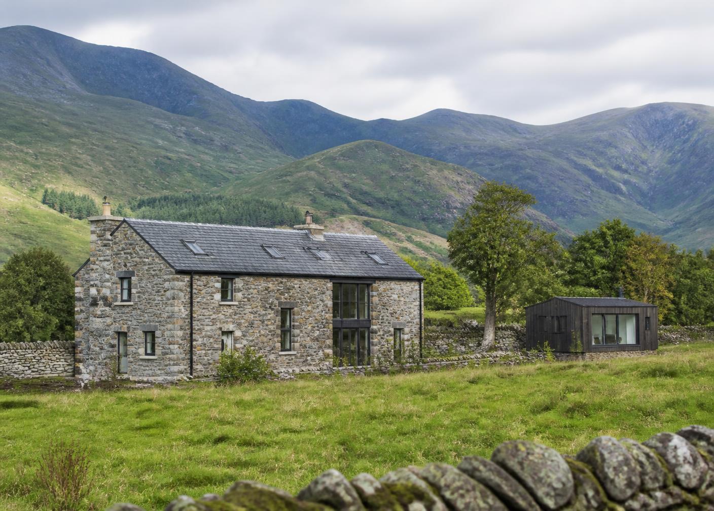 A traditional Cumbrian stone home with outbuildings